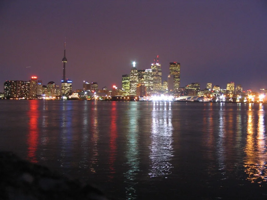 City lights reflecting off the water after dark